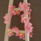Pink cherry blossom fairy lights on a decorative ladder.