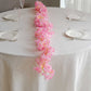 Pink cherry blossom fairy lights on a table setting.