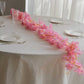 Pink cherry blossom fairy lights on a table setting.