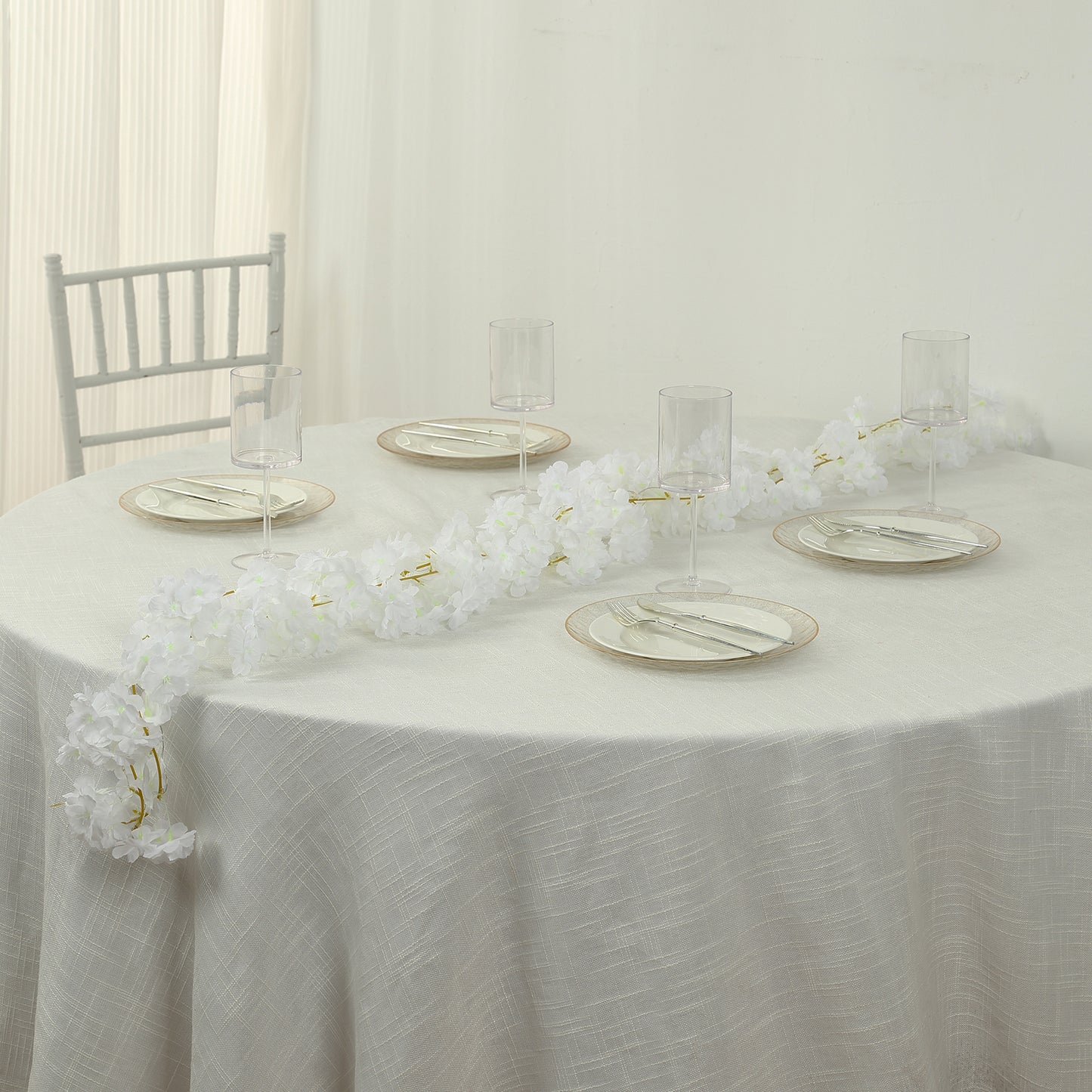 Warm white cherry blossom garland LED string lights on a table setting.