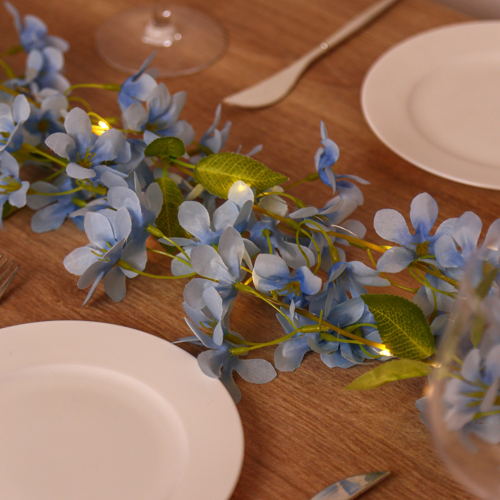 Blue jasmine silk flower garland with warm white LED fairy lights.
