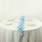 Blue jasmine silk flower garland with warm white LED lights on a table.