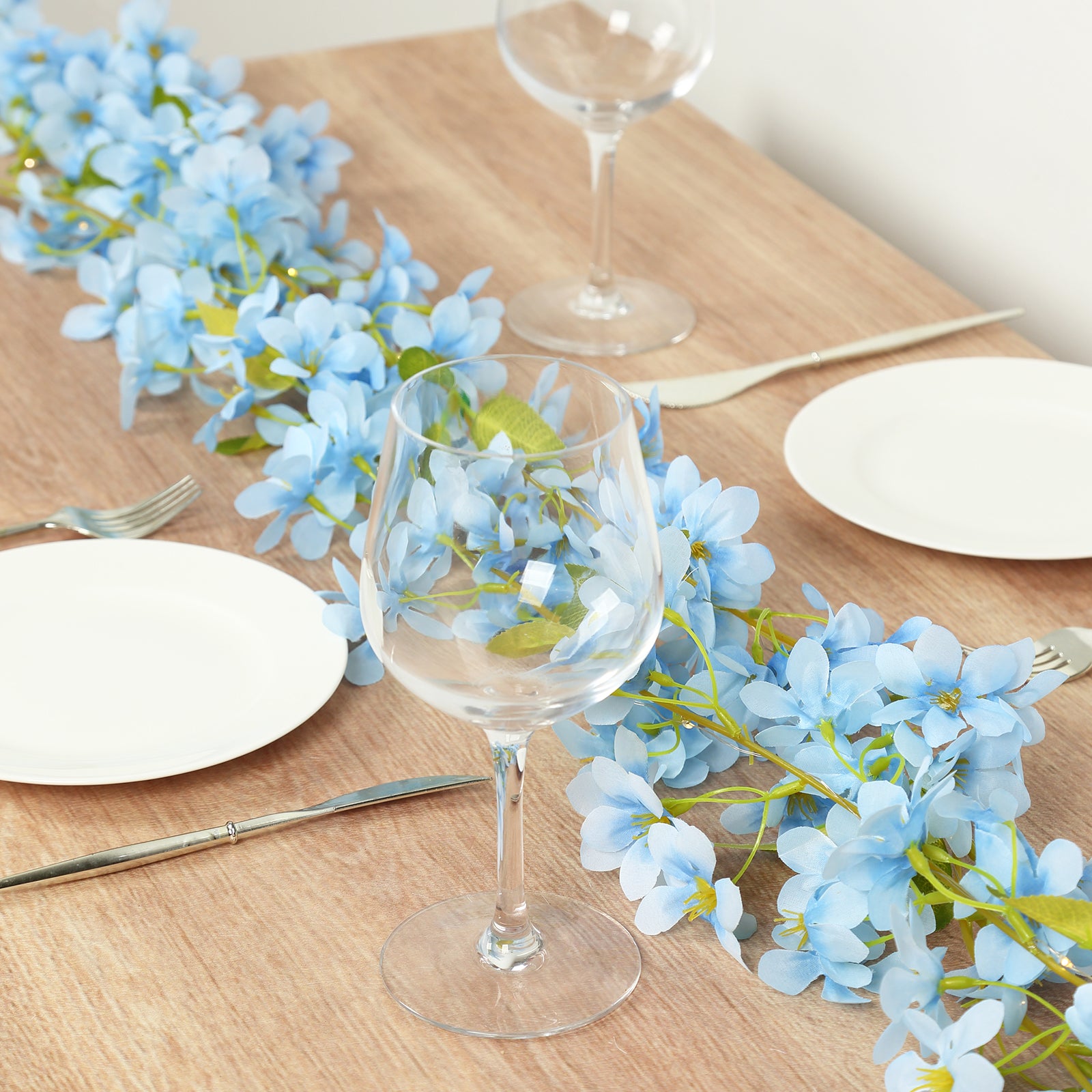 Blue jasmine silk flower garland with warm white LED lights.