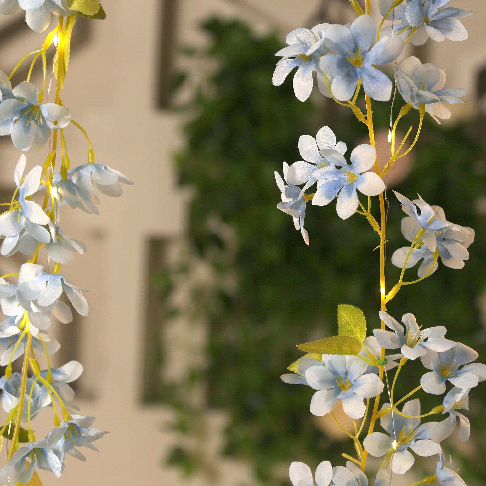 Blue jasmine silk flower garland with warm white LED fairy lights.