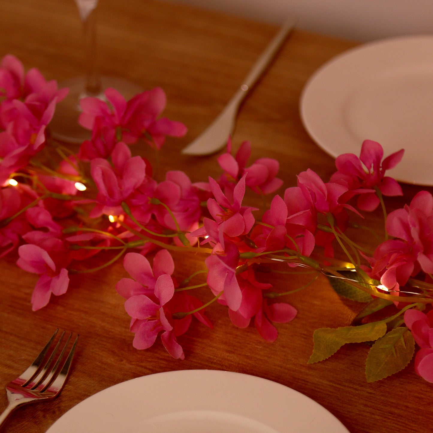 Pink jasmine silk flower garland with warm white LED fairy lights.