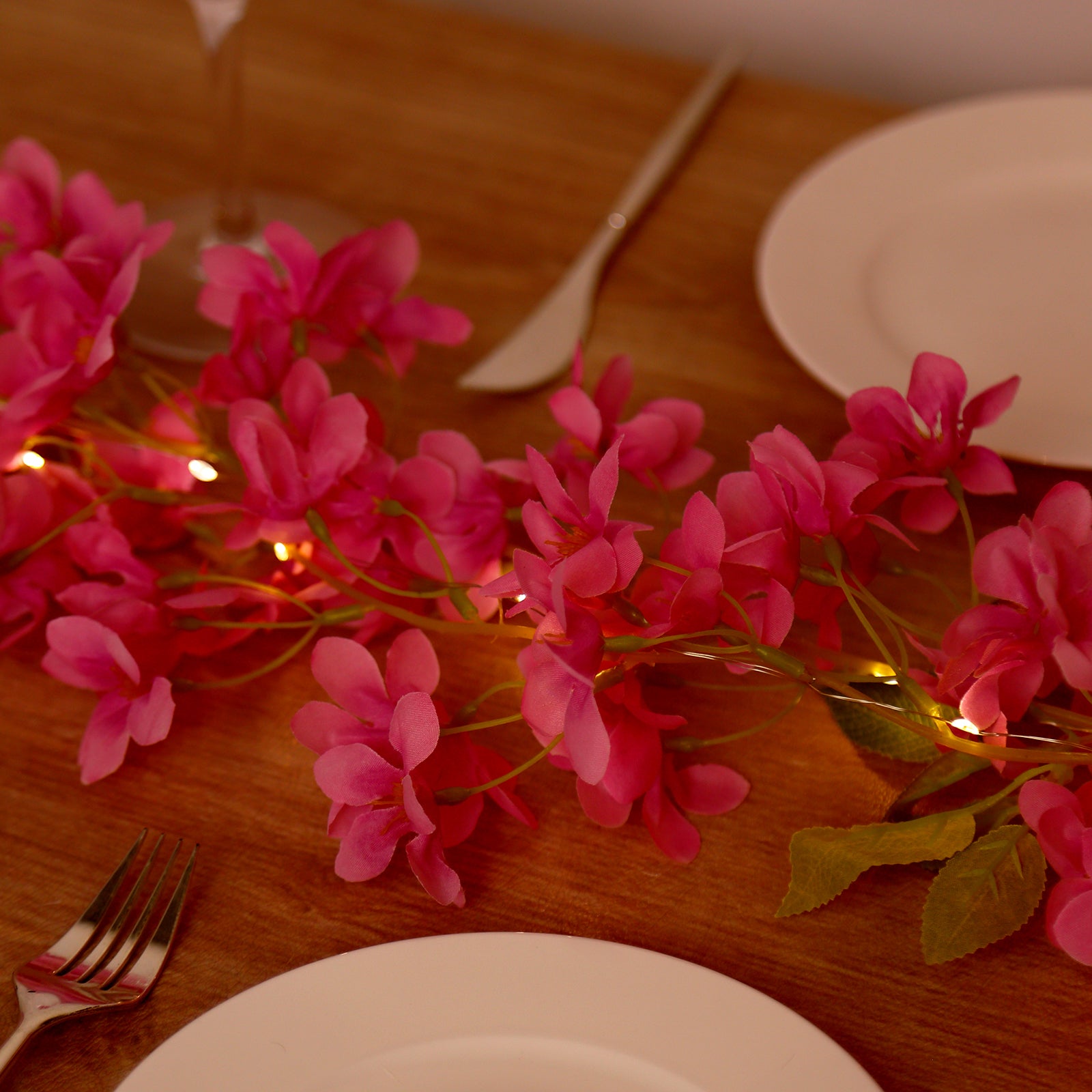 Pink jasmine silk flower garland with warm white LED fairy lights.
