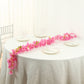 Pink jasmine flower garland with warm white LED lights on a table setting.