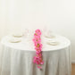 Pink jasmine silk flower garland with warm white LED lights on a table.
