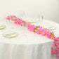 Pink jasmine flower garland with warm white LED lights on a table setting.