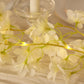White jasmine flower garland with warm white LED fairy lights.