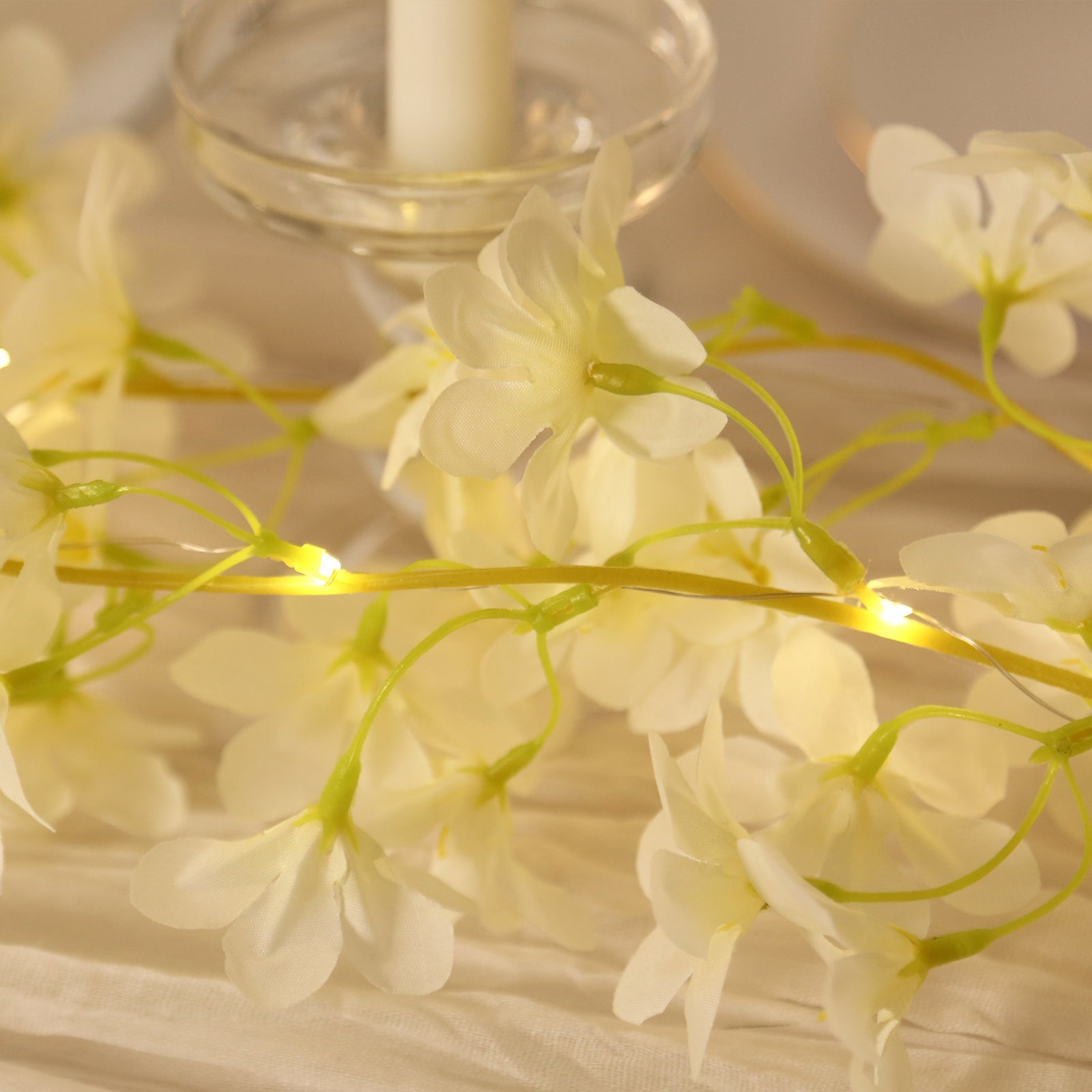 White jasmine flower garland with warm white LED fairy lights.
