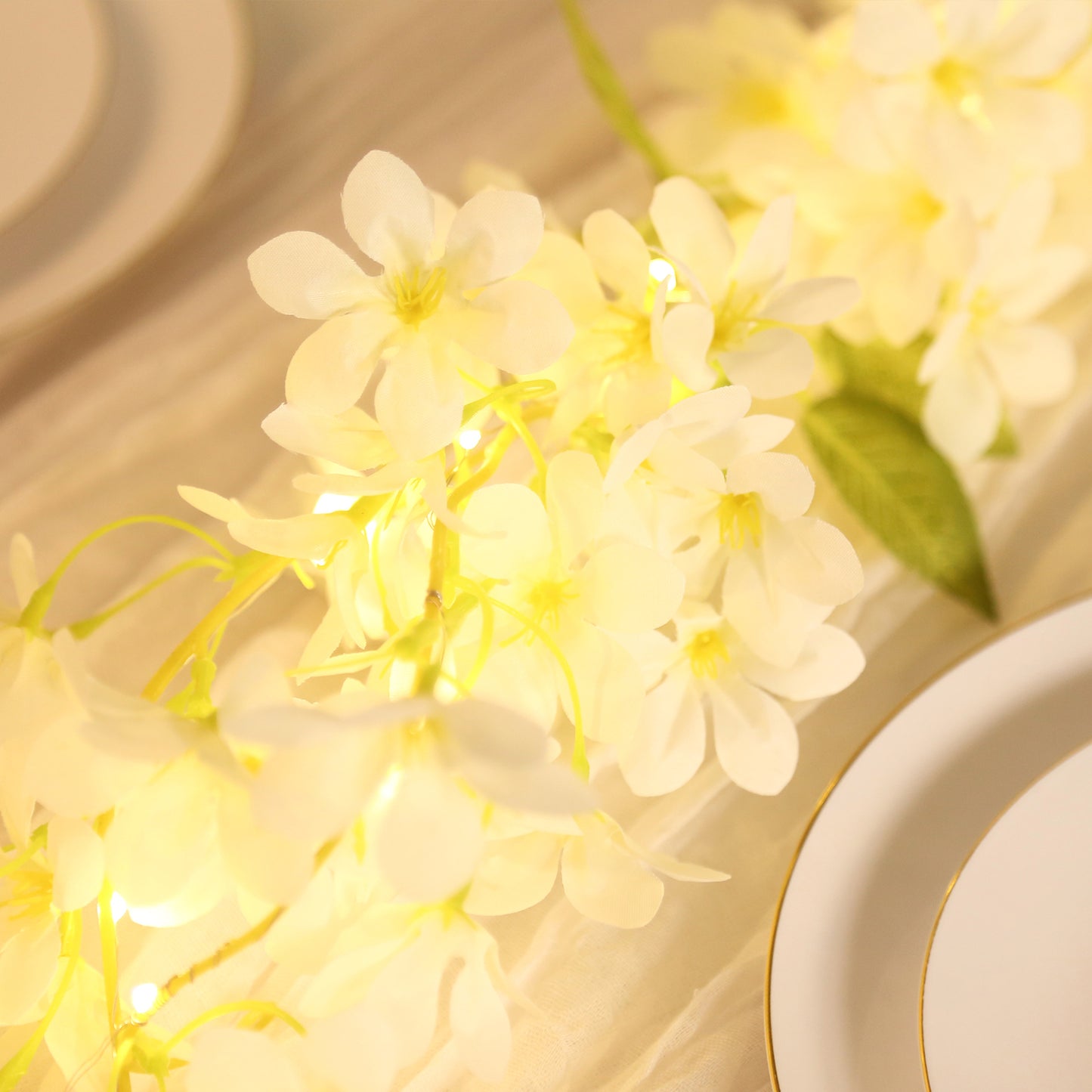 White jasmine flower garland with warm white LED lights.
