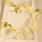 White jasmine silk flower garland with warm white LED fairy lights.