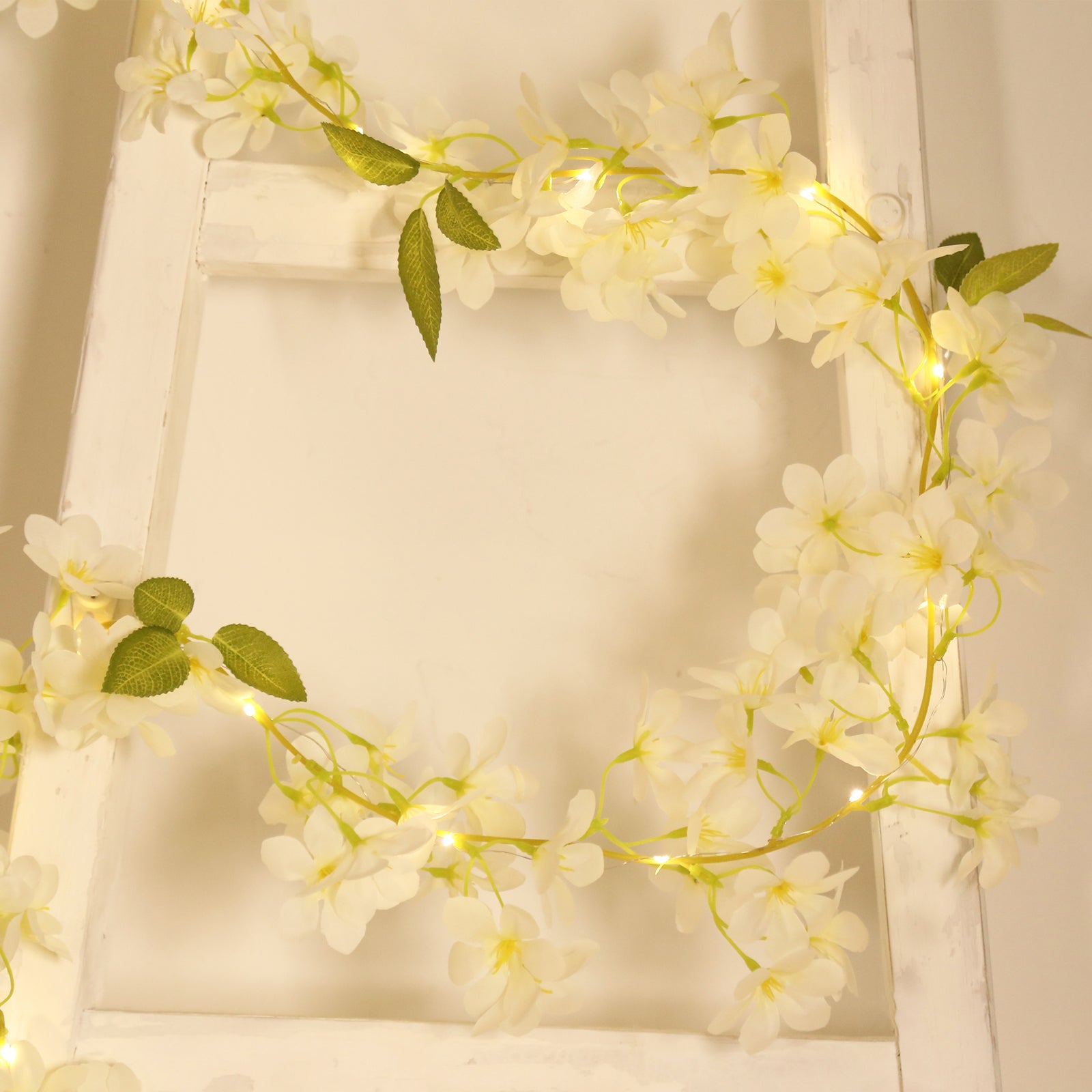 White jasmine silk flower garland with warm white LED fairy lights.