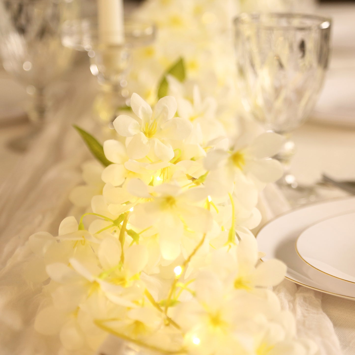 White jasmine silk flower garland with warm white LED lights.