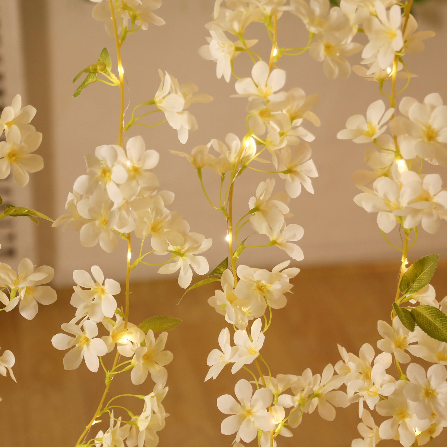 White jasmine silk flower garland with warm white LED fairy lights.
