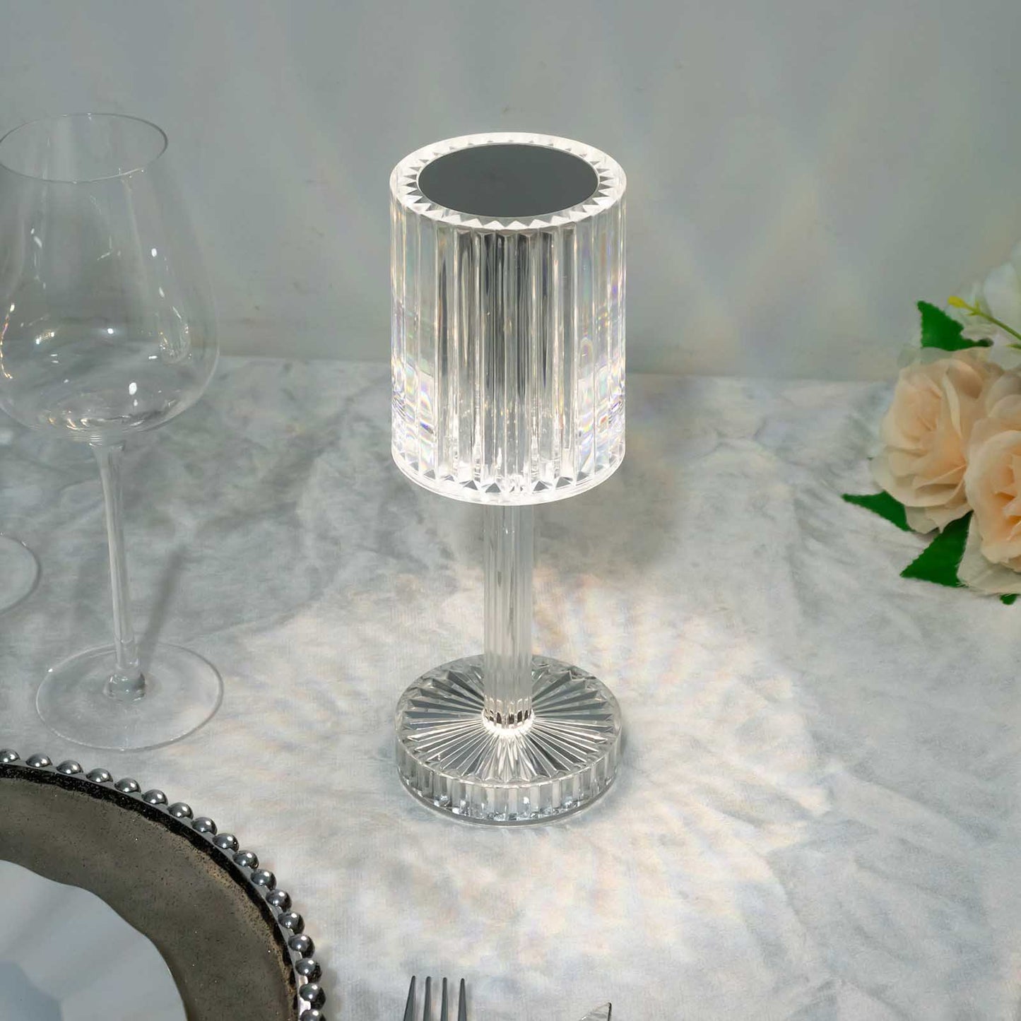 Color changing LED crystal cylinder table lamp in clear acrylic.