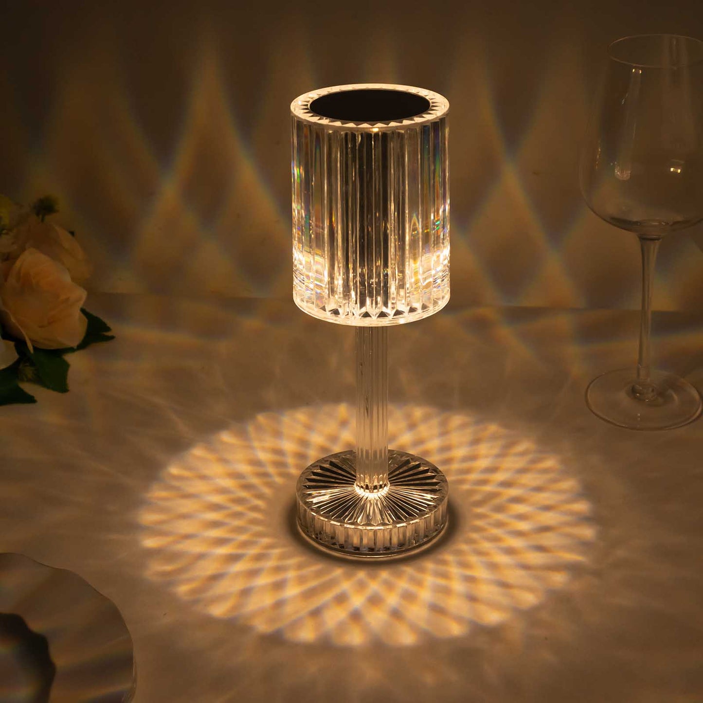 Color changing crystal cylinder table lamp with a warm glow.