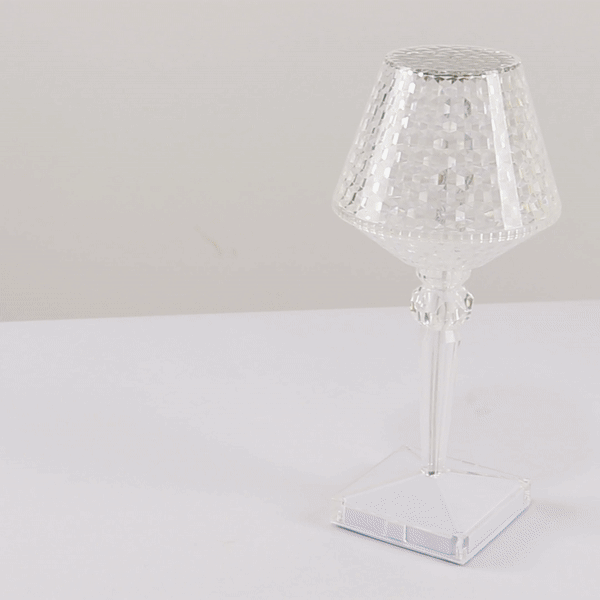 Color changing crystal cup shape accent lamp on a white surface.