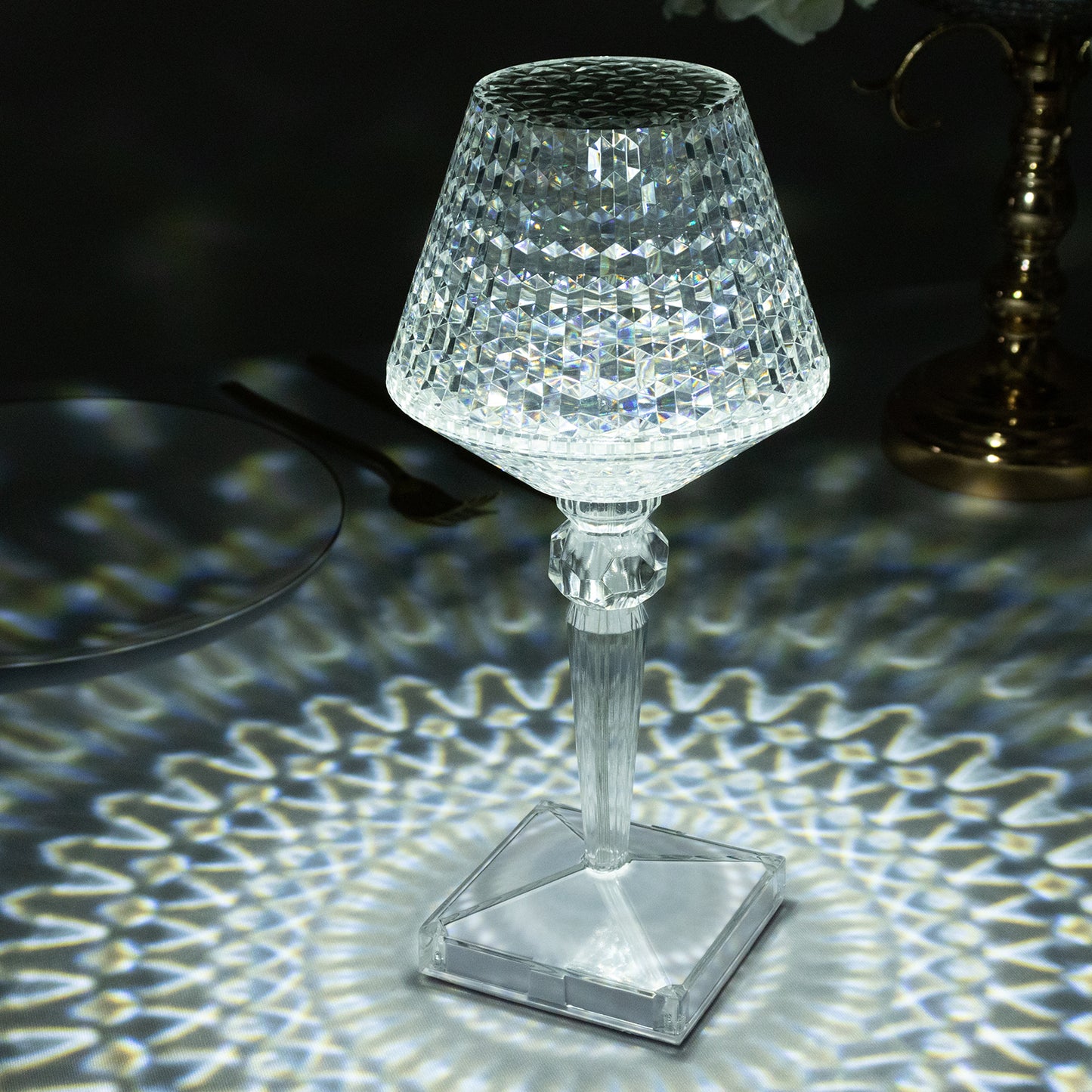 Color changing crystal table lamp with intricate design and soft lighting.