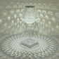 Color changing clear acrylic crystal lamp with light patterns.