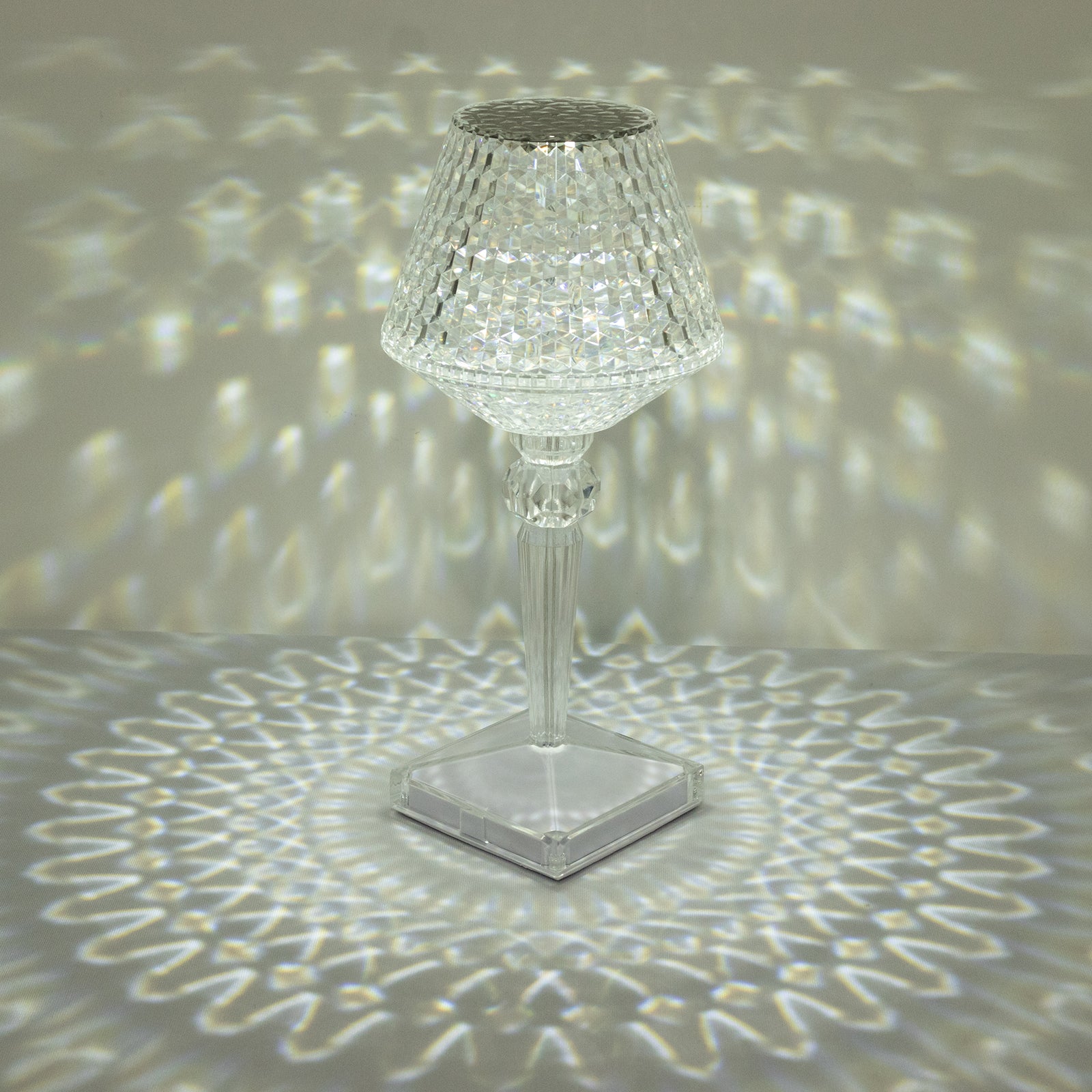 Color changing clear acrylic crystal lamp with light patterns.