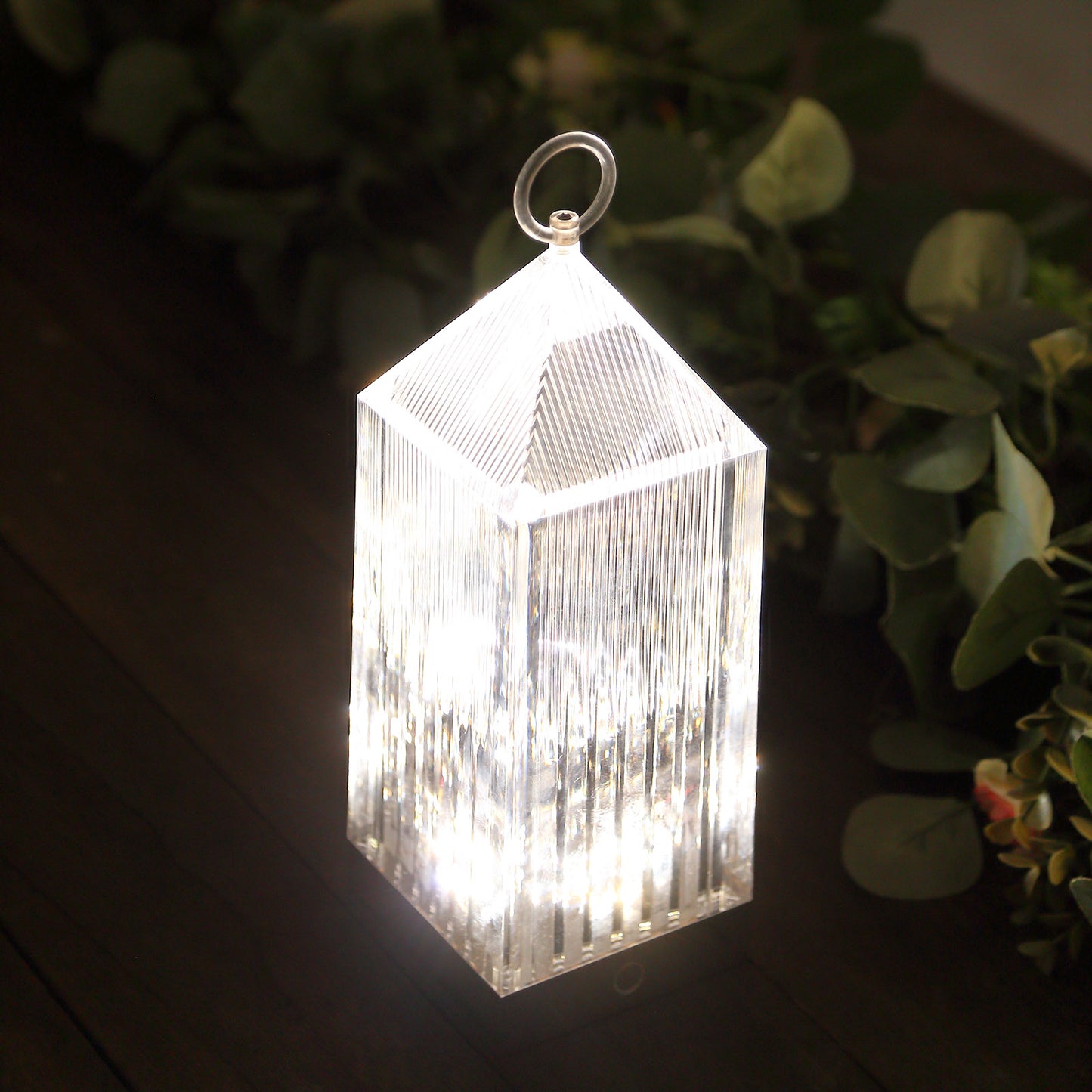 Clear acrylic LED lantern table lamp with touch control.