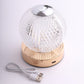 Dimmable LED crystal ball lamp with gold base and touch control.
