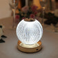 Dimmable LED crystal ball lamp with touch control, glowing softly in white.