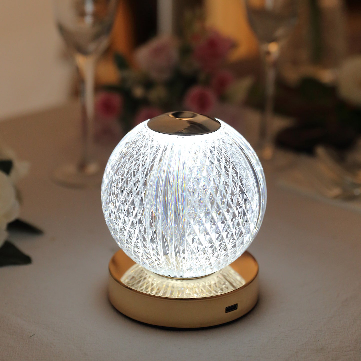 Dimmable LED crystal ball lamp with touch control, glowing softly in white.