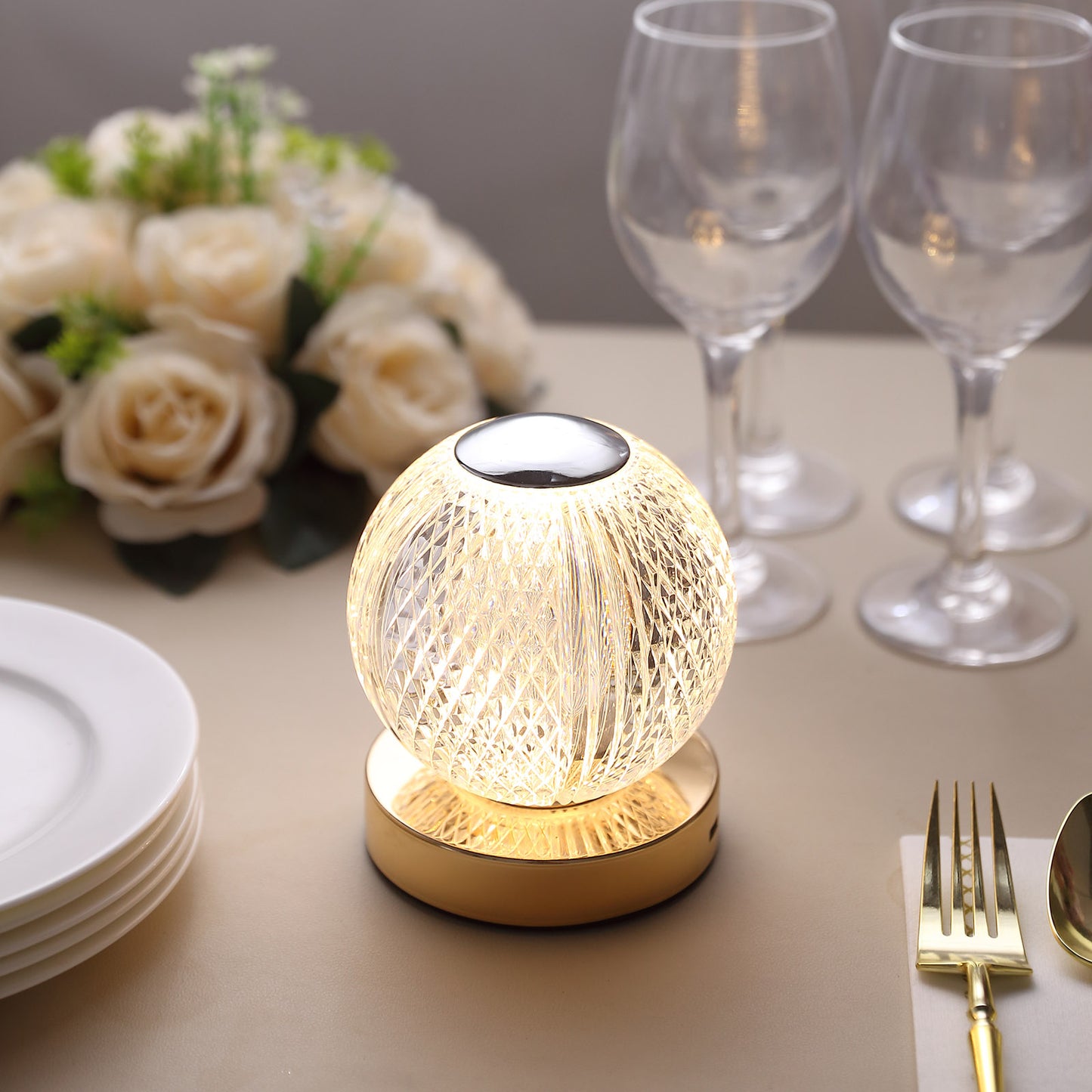 Dimmable LED centerpiece lamp with a warm golden glow.