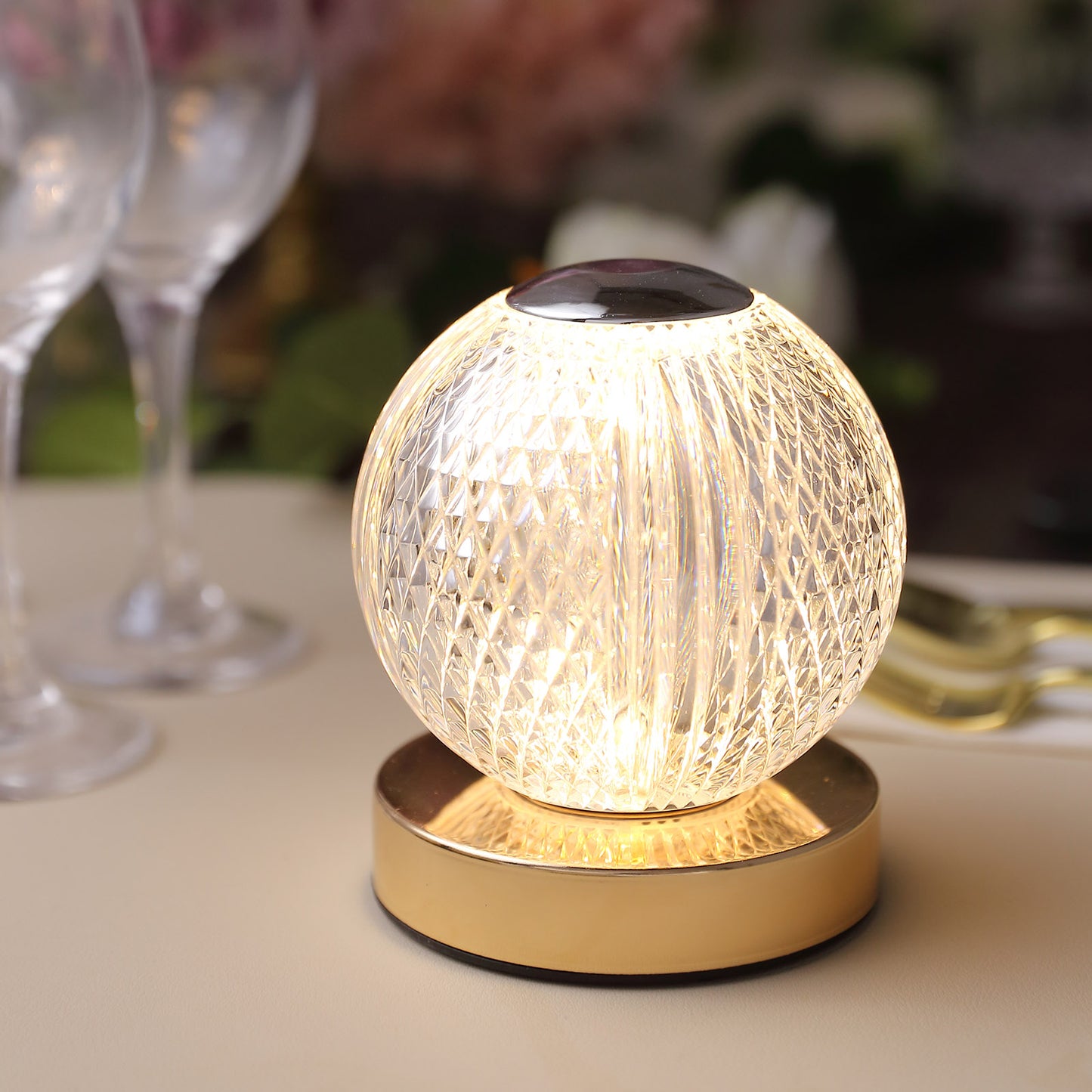 Dimmable LED crystal ball lamp with touch control and gold base.