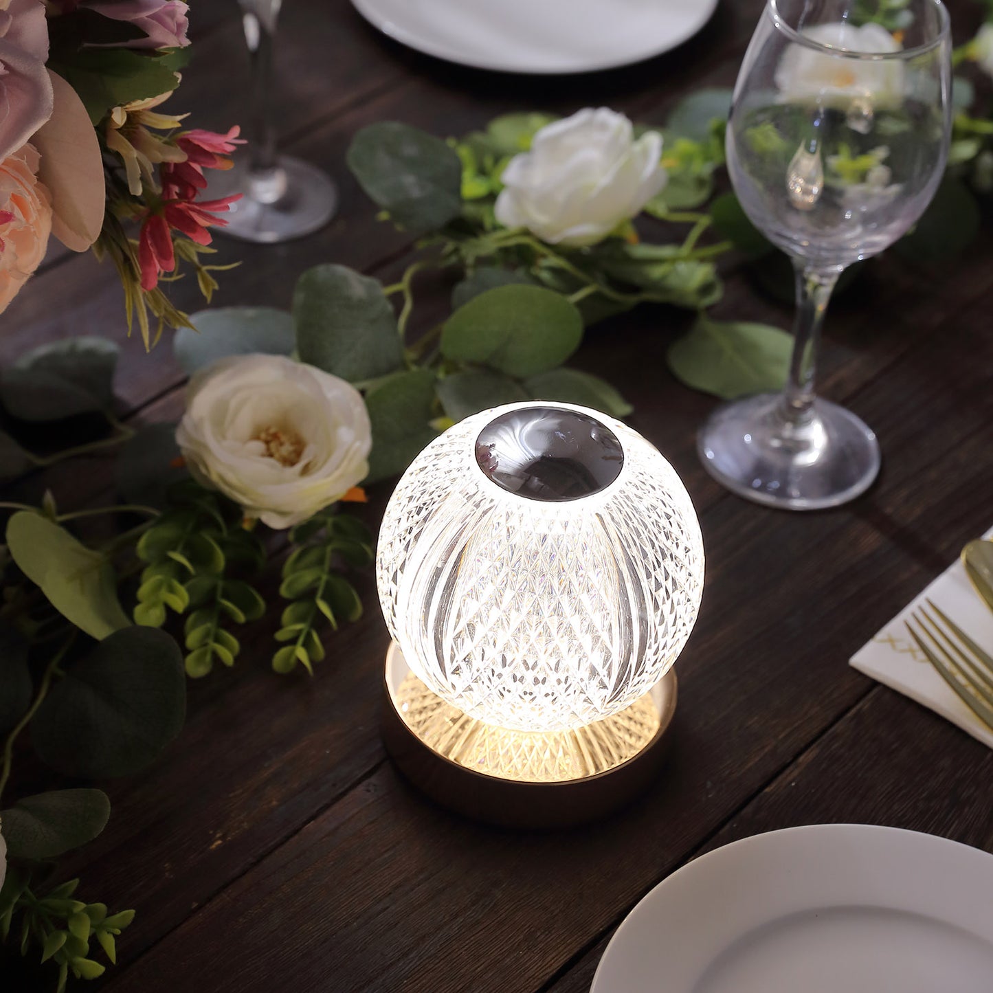 Dimmable LED crystal ball lamp with touch control, glowing warm white light.