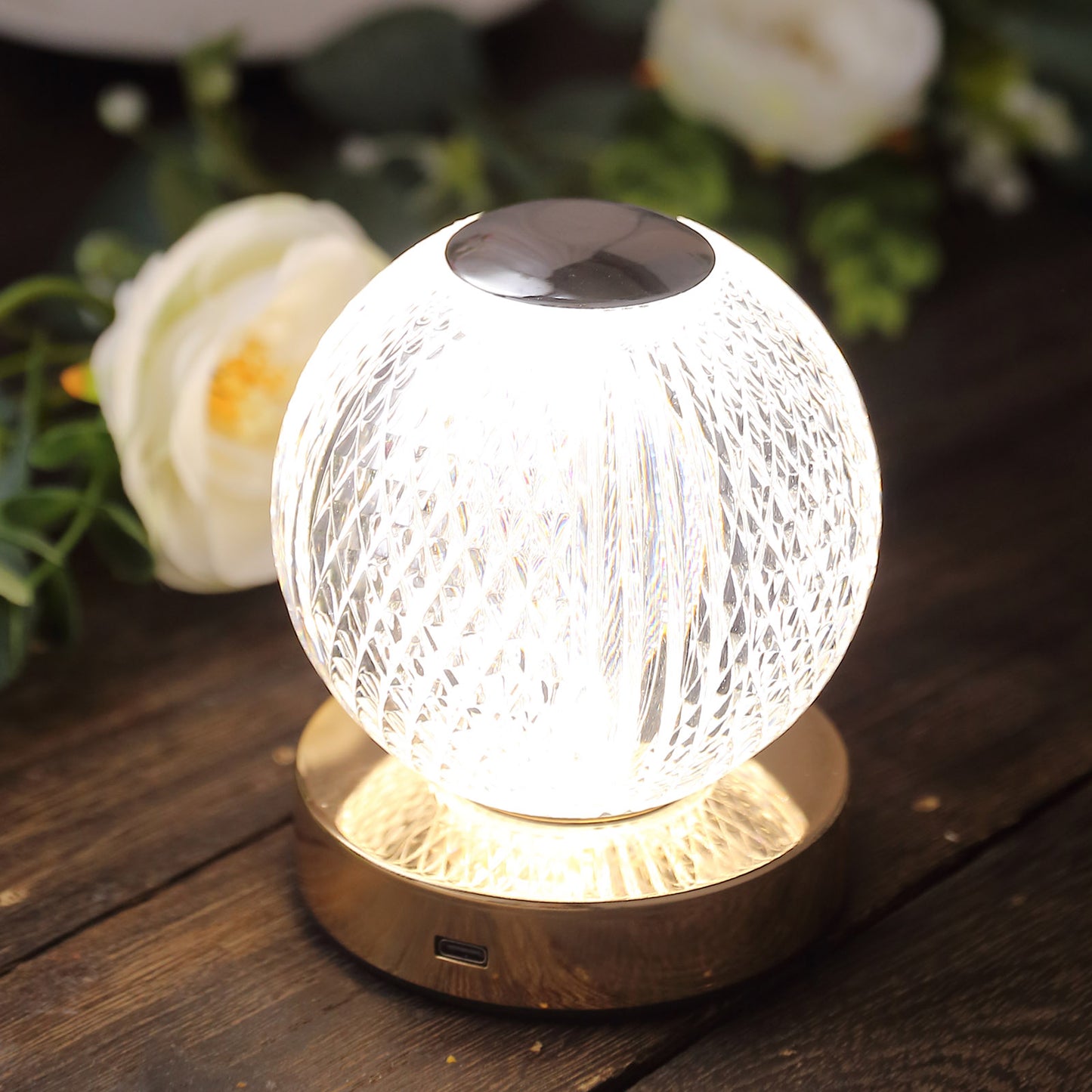 Dimmable LED centerpiece lamp with diamond cut design in clear and gold.