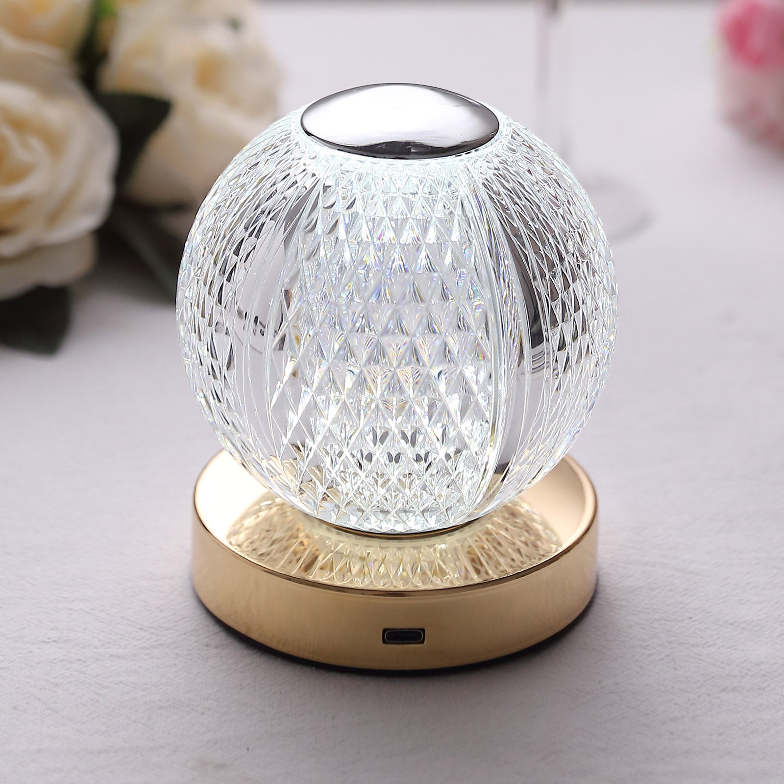 Dimmable LED crystal ball lamp with touch control, cordless, in clear glass.