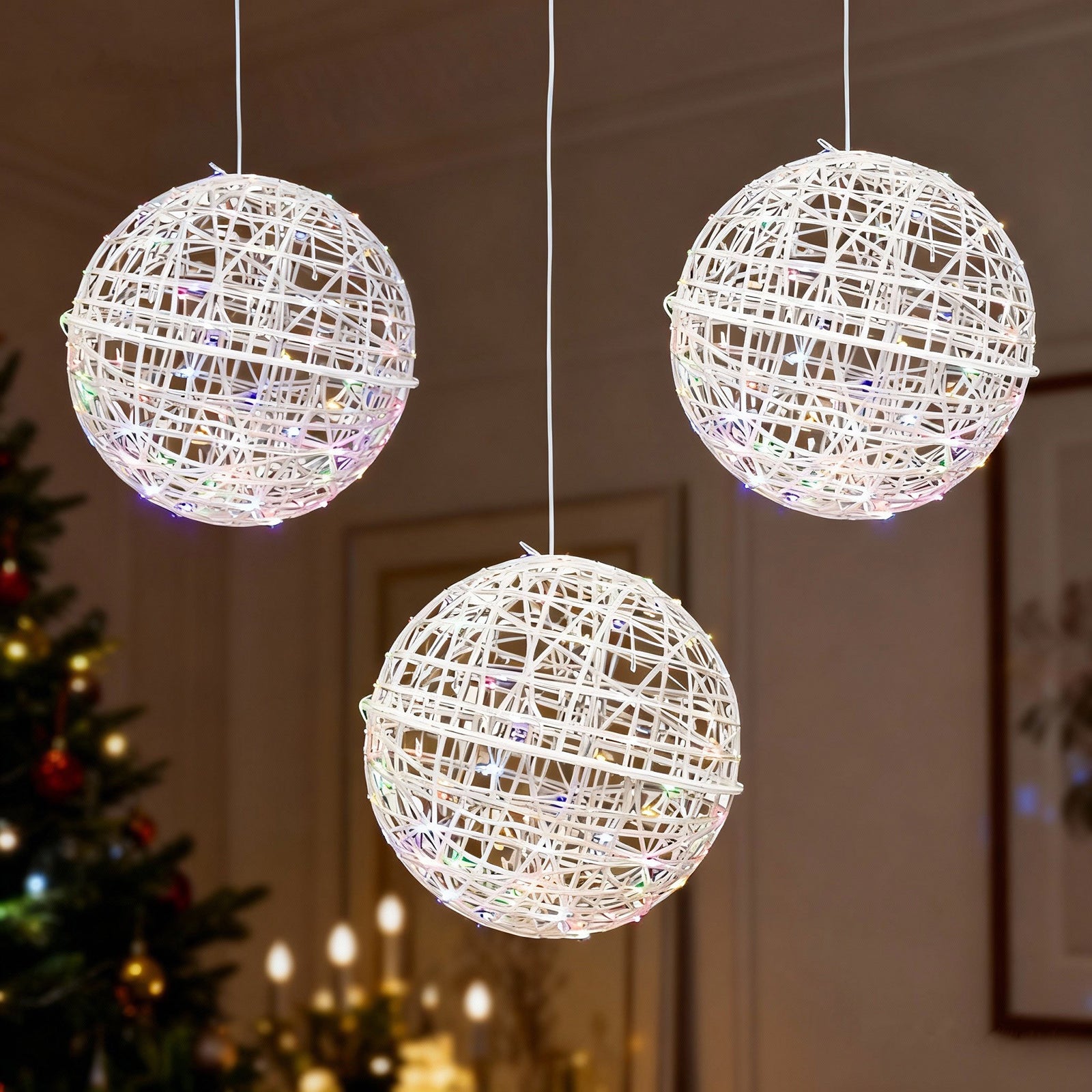 White woven rattan orbs with multicolor LEDs.