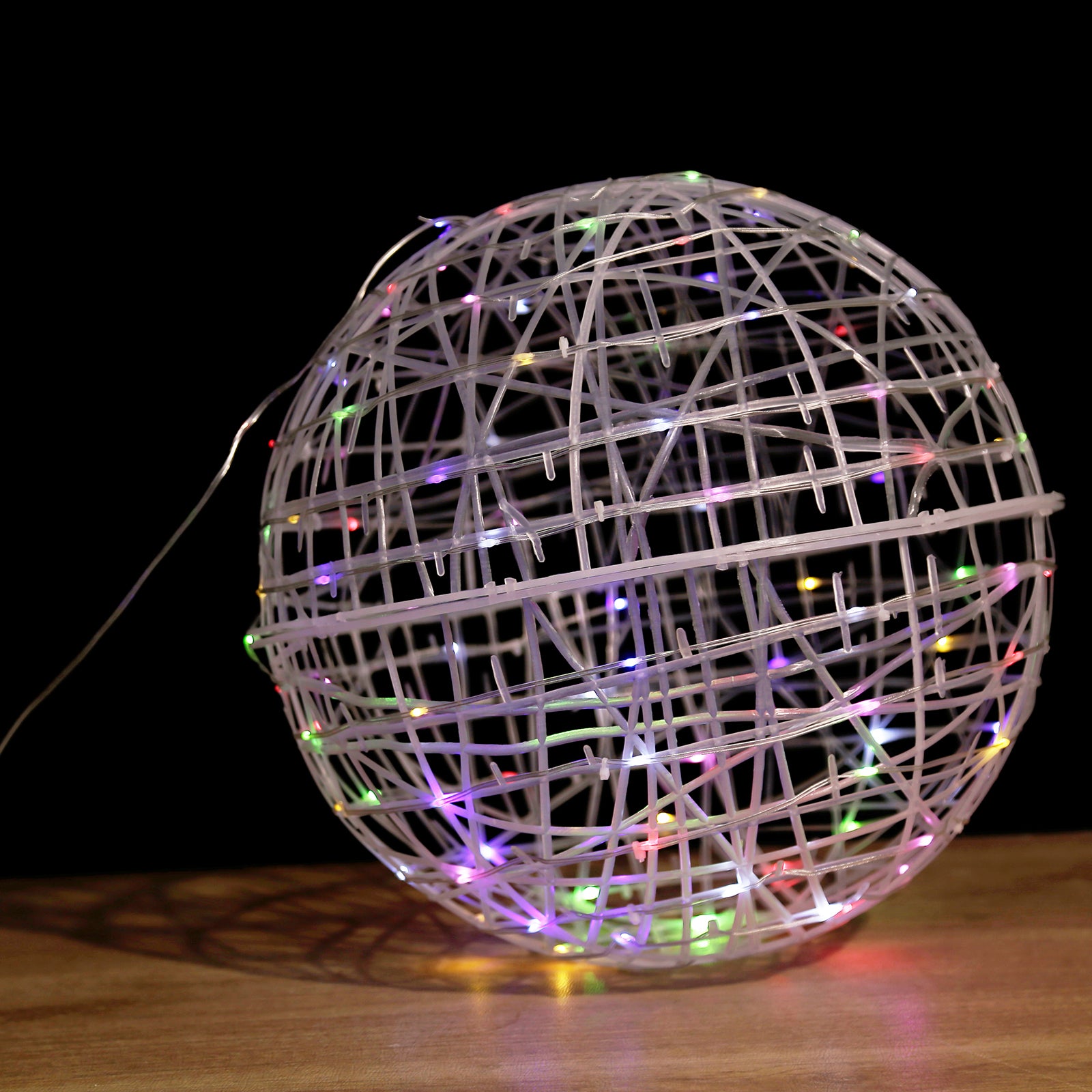 White woven rattan orb with multicolor LEDs and decorative lighting.