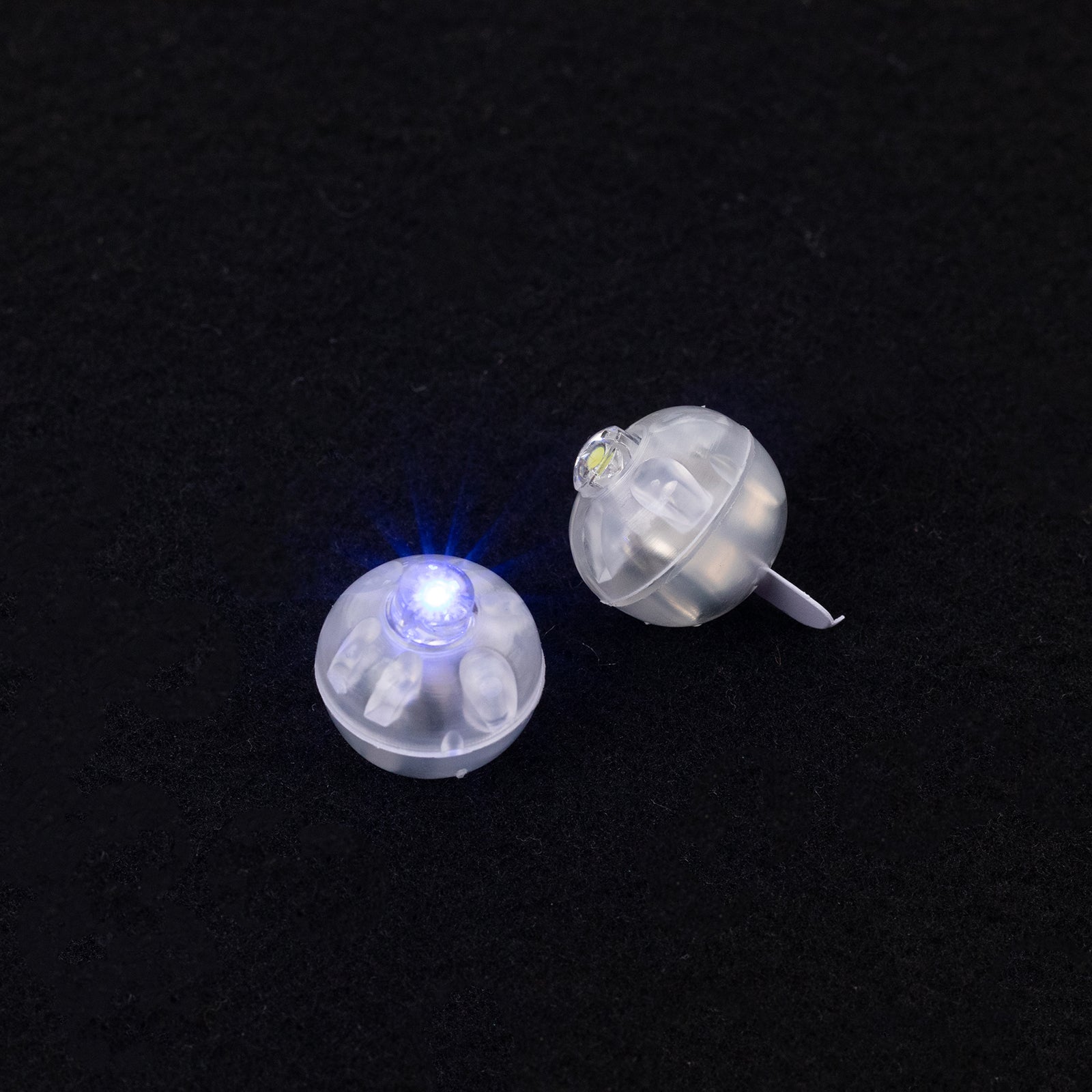 Light blue mini LED balls, waterproof and battery operated, 0.5" in size.