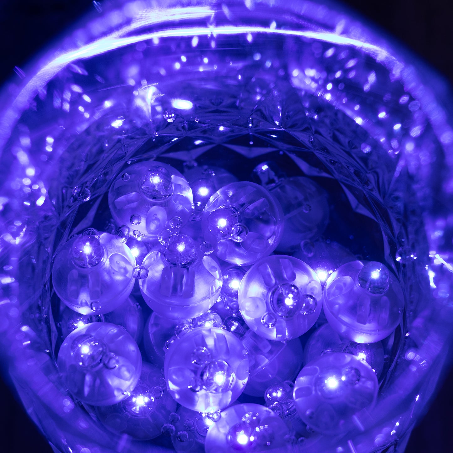 Purple mini LED balls in a clear container, illuminated and waterproof.