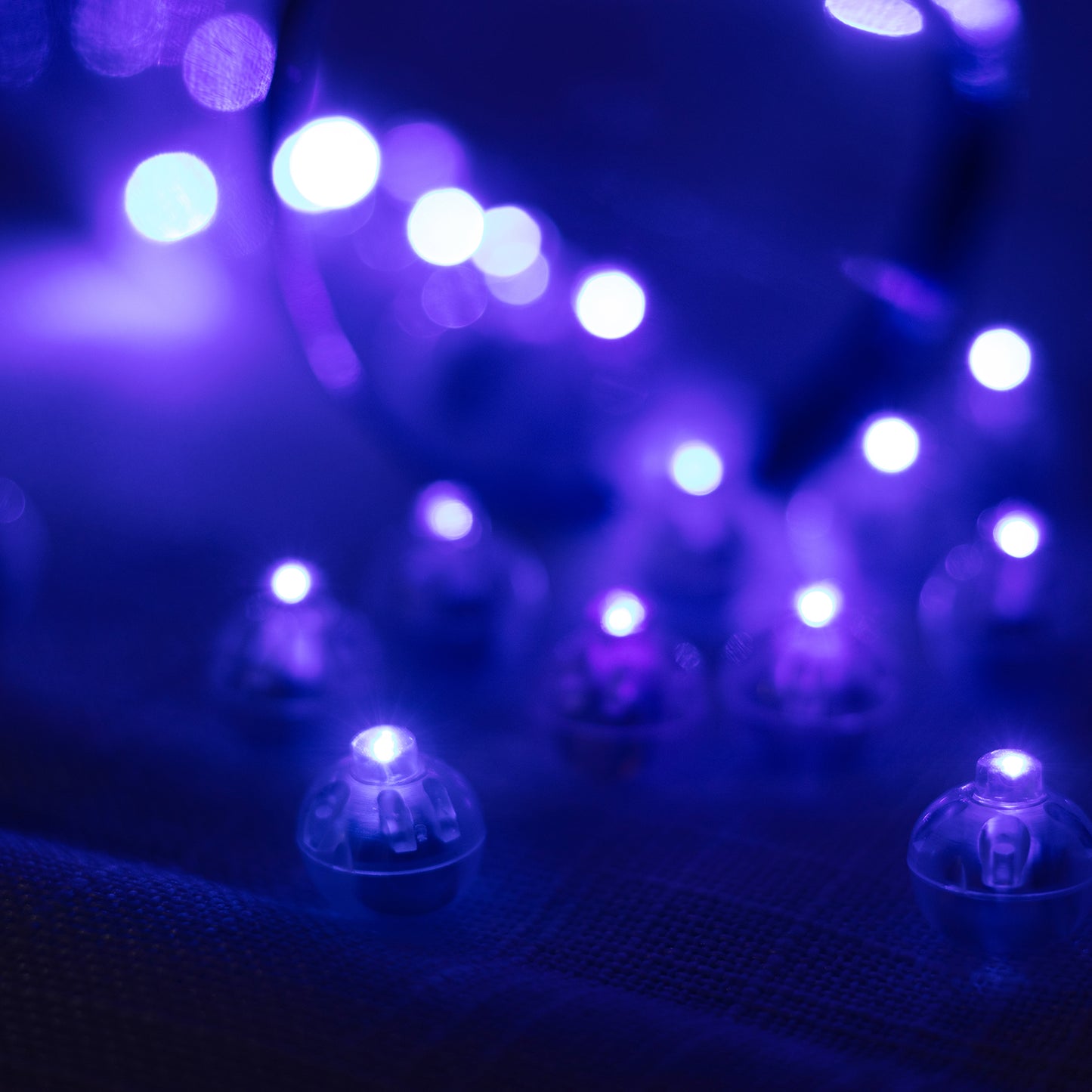 Light blue mini LED balls, waterproof battery-operated balloon lights. #whtbkgd