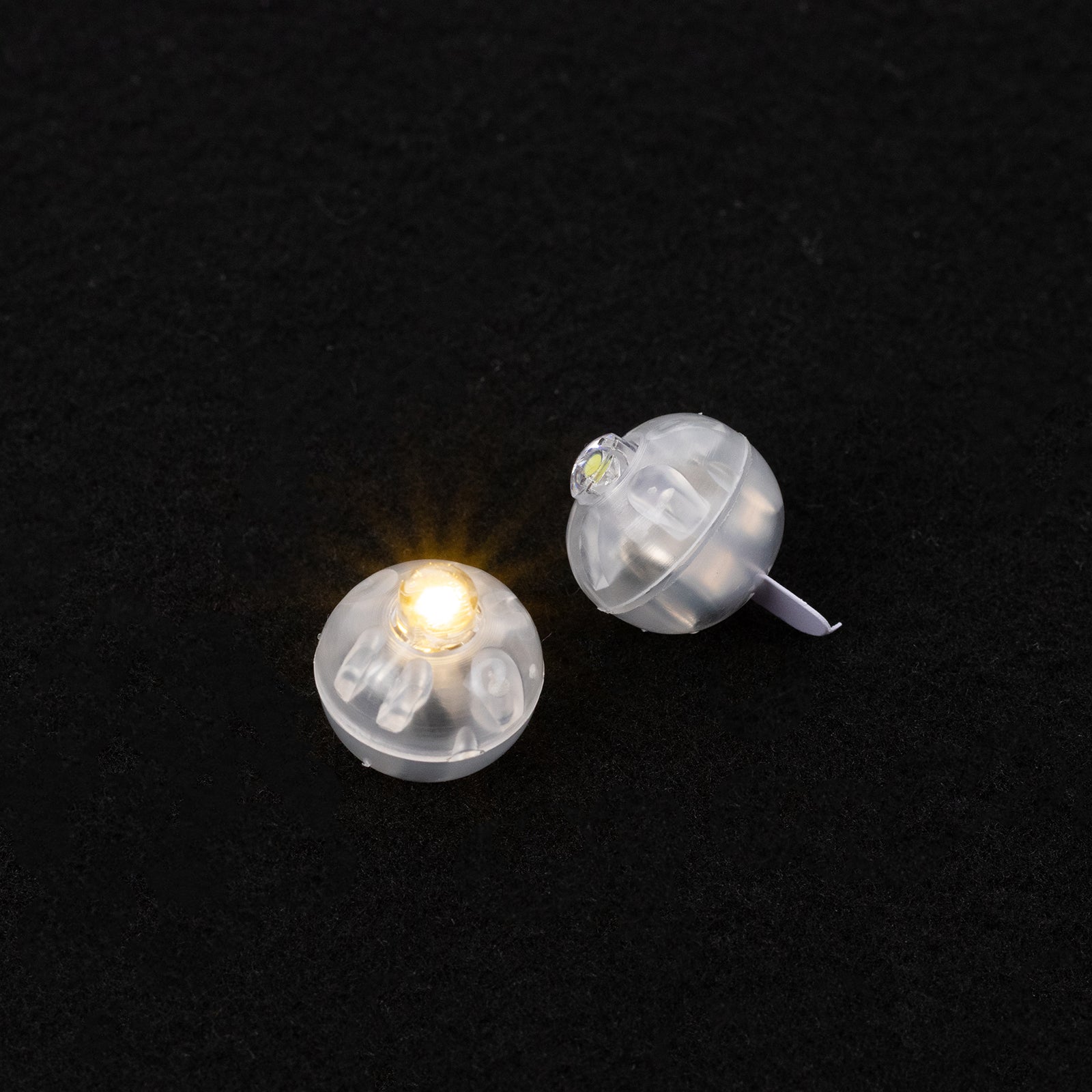Warm white mini LED balls, waterproof and battery operated, perfect for decorations.