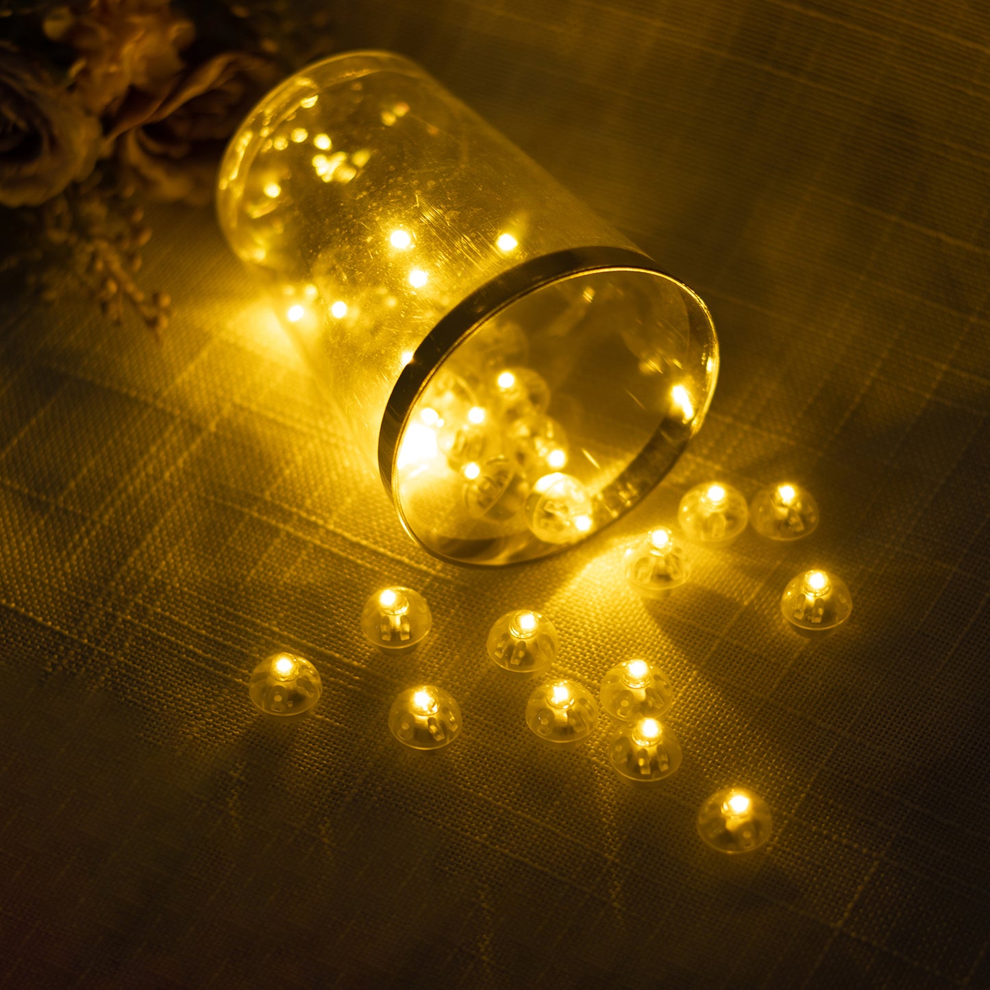 Warm white mini LED ball lights, waterproof and battery-operated, in a scattered arrangement.
