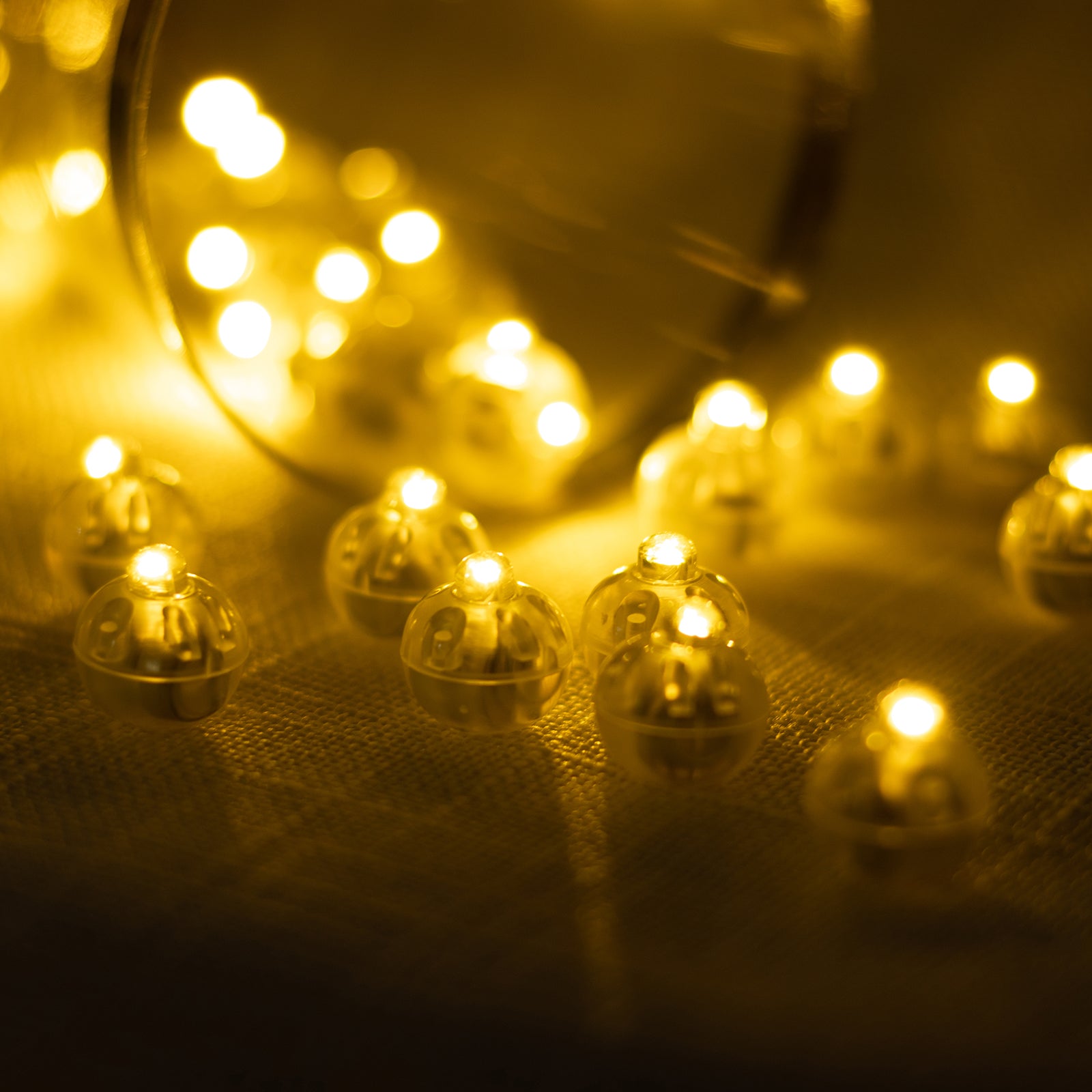 Warm white mini LED balloon lights in a decorative arrangement. #whtbkgd