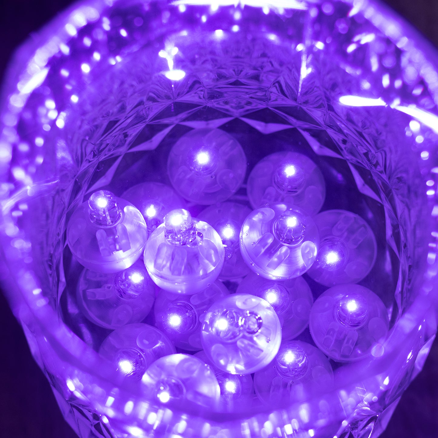 Purple mini LED balls in a clear container, illuminated and waterproof.