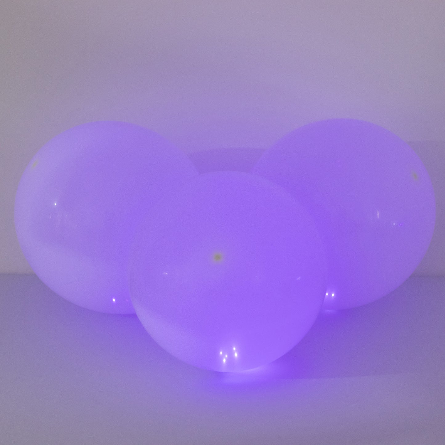 Purple round mini LED balls, waterproof battery-operated balloon lights.