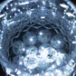 White round mini LED balls in a crystal bowl, glowing softly.
