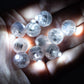 White mini LED balls in hand, battery-operated and waterproof.