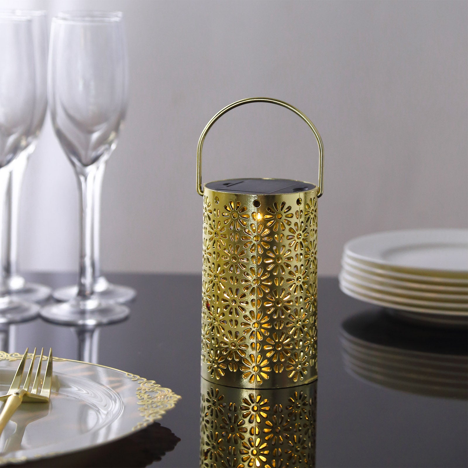 Gold LED lantern with floral design, decorative for garden or indoor use.