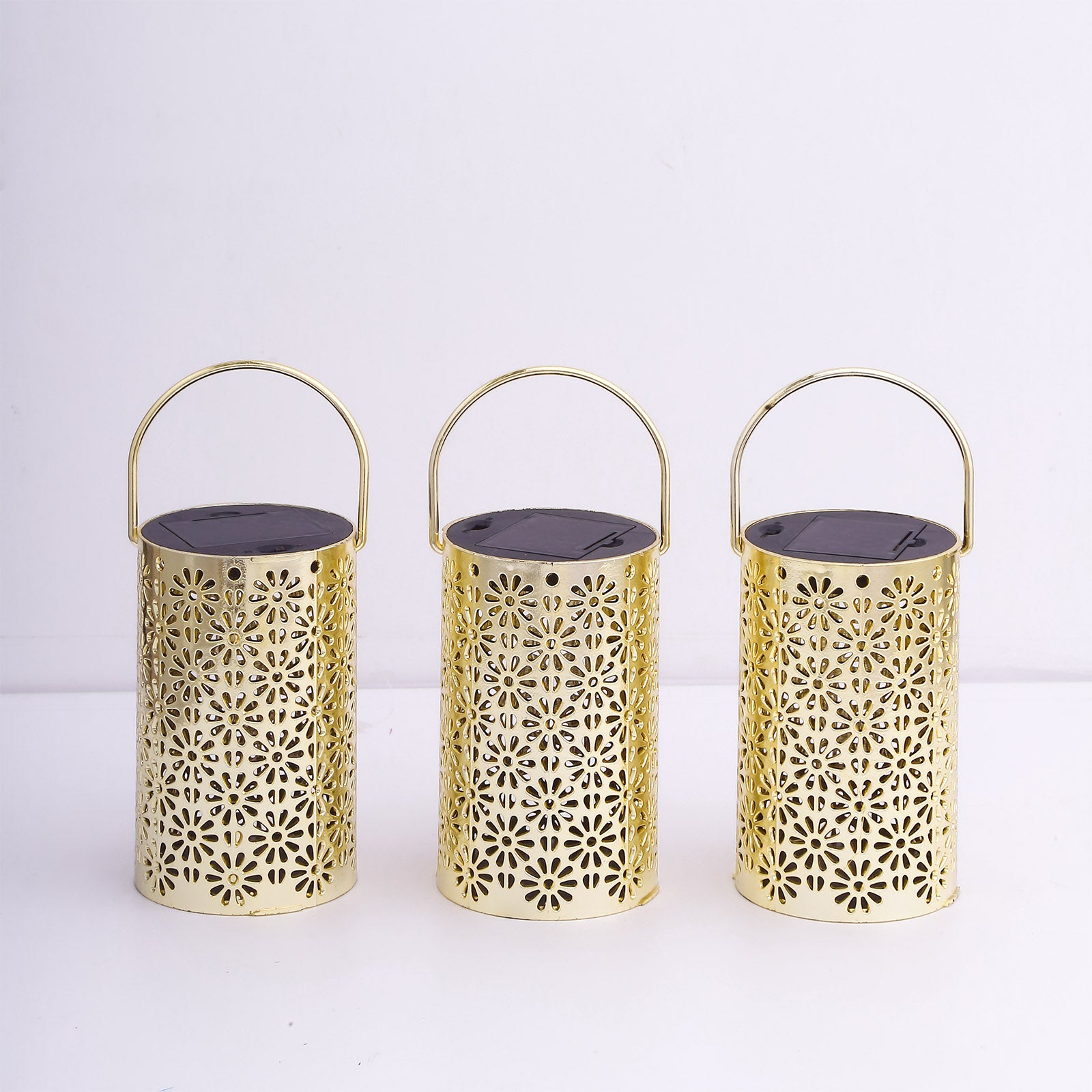 Gold decorative LED lanterns with floral design, battery operated, set of three.