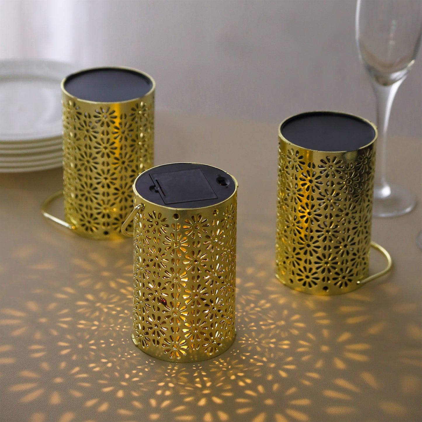 Gold decorative LED lanterns with flower design, battery operated, set of three.